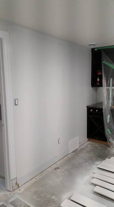 basement wall in the process of being painted white