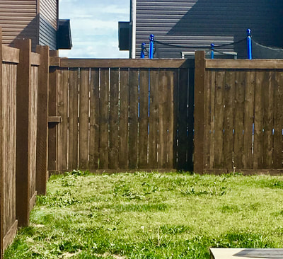 perfectly painted brown backyard wooden fence