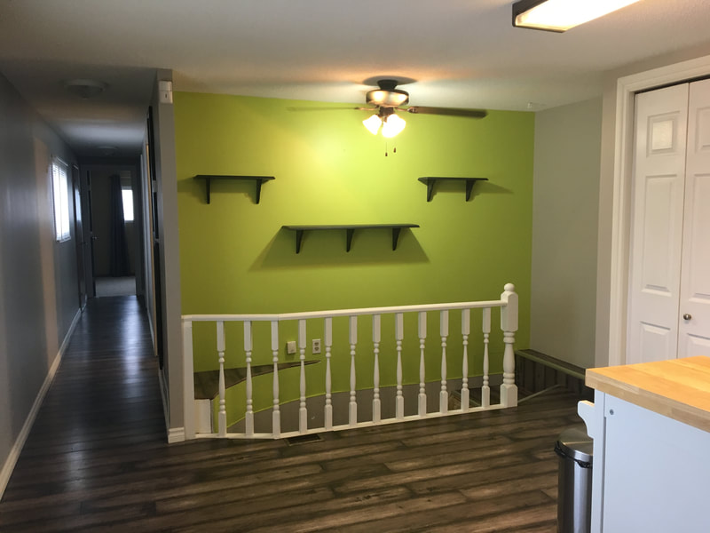 painted second floor showcasing contrast between vibrant green and the rest of the hallway